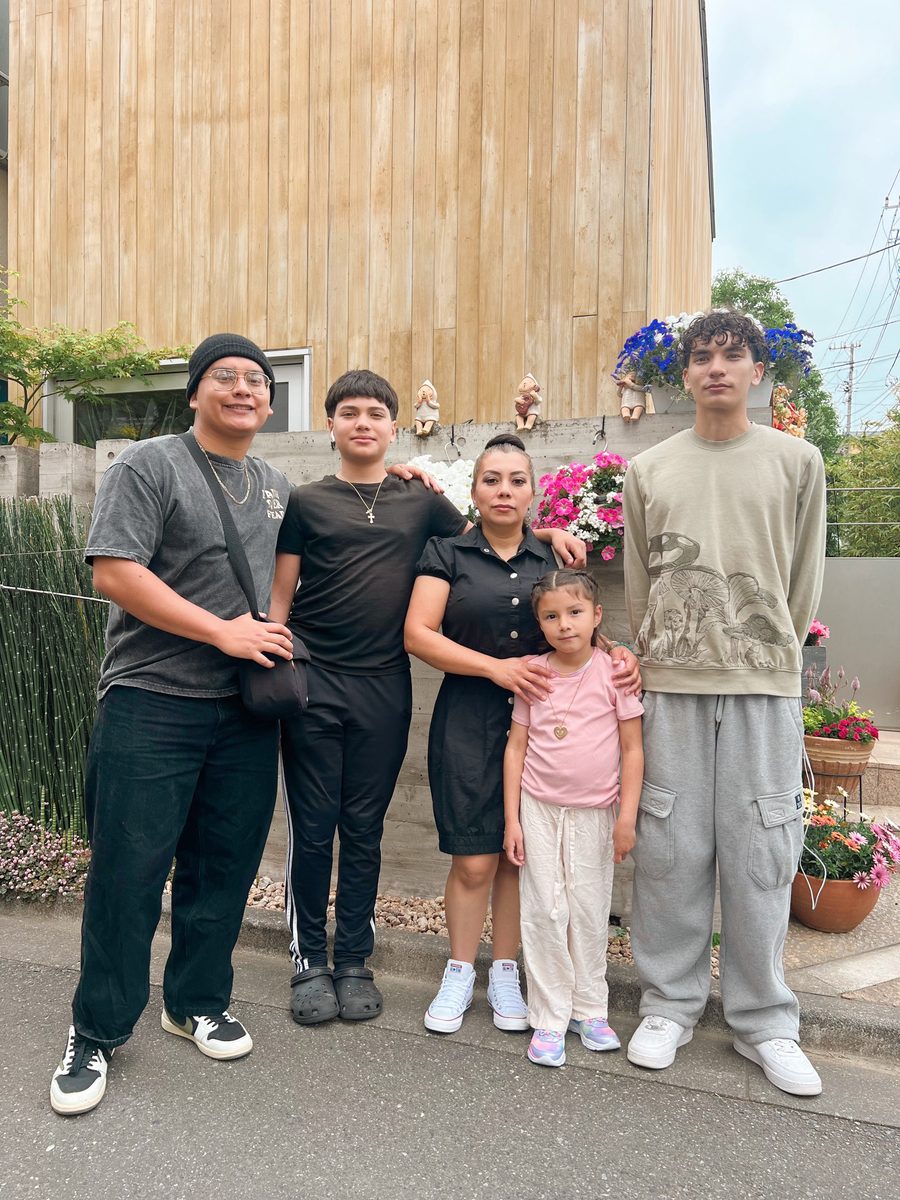 Karina and her four children together outside their home