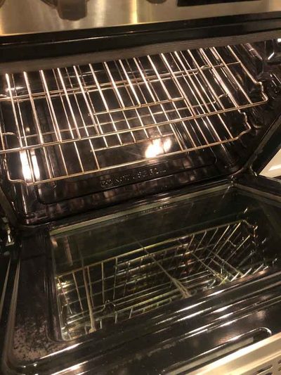 The inside of a freshly cleaned oven with spotless racks and glass door